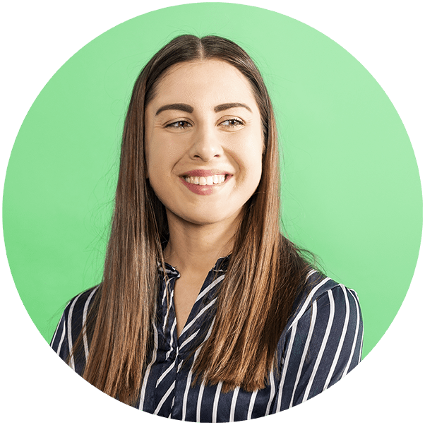 The image shows a smiling woman with long, straight hair and a striped shirt, photographed against a light green background. Her eyes are turned to the side, and she looks happy and relaxed.