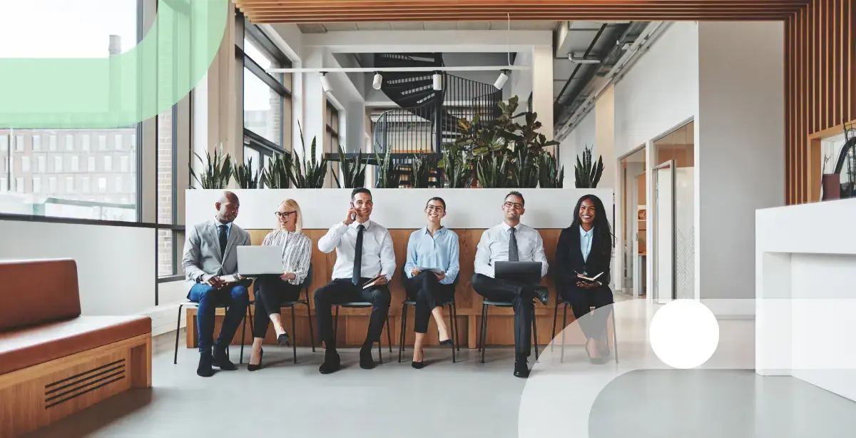 Several business people with different ethnicities sitting side by side in an office setting