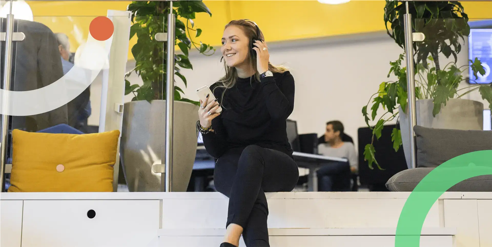 Young woman holding an smartphone and talking via a headset.